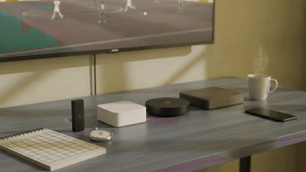 Streaming devices and a scoring checklist beside a TV, comparing IPTV services during a free trial
