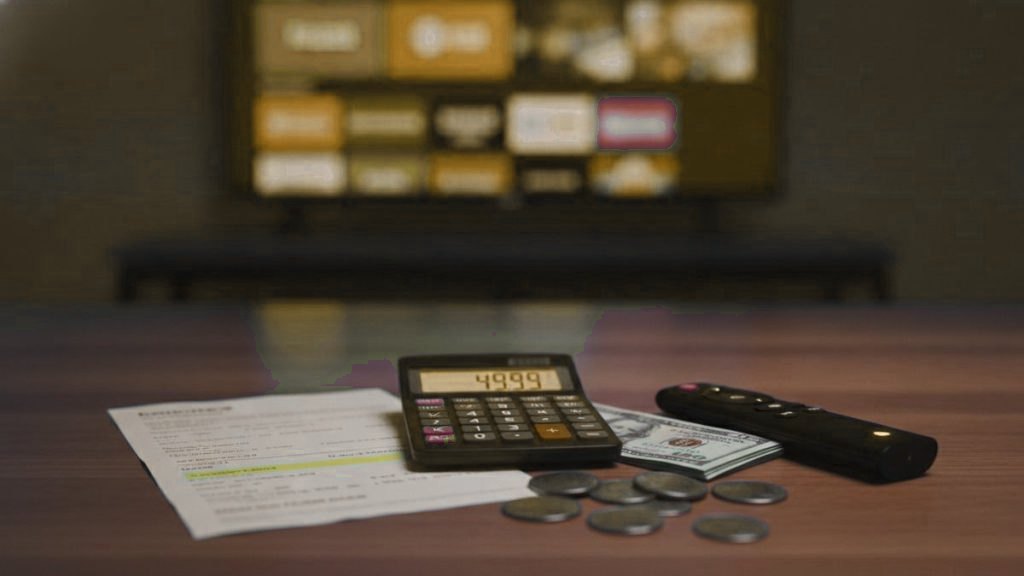 A calculator, US dollars and a streaming stick, showing how much an IPTV subscription costs per screen